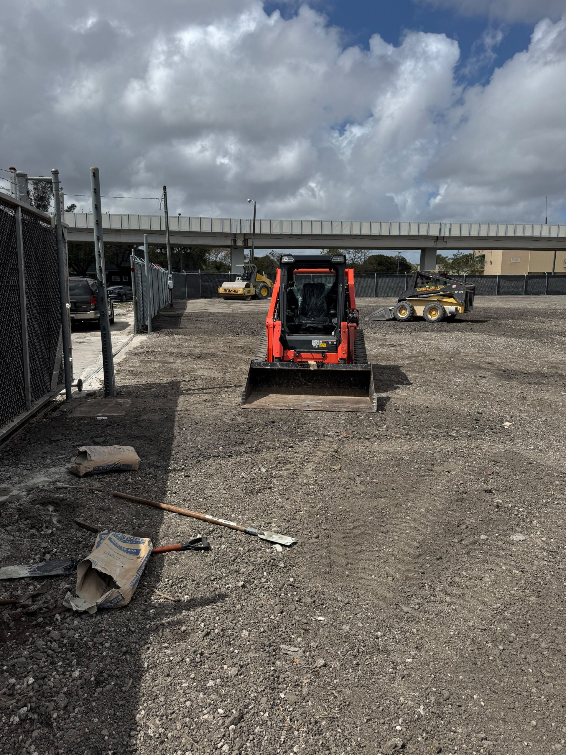 Orange track loader on a South Florida site prep job
