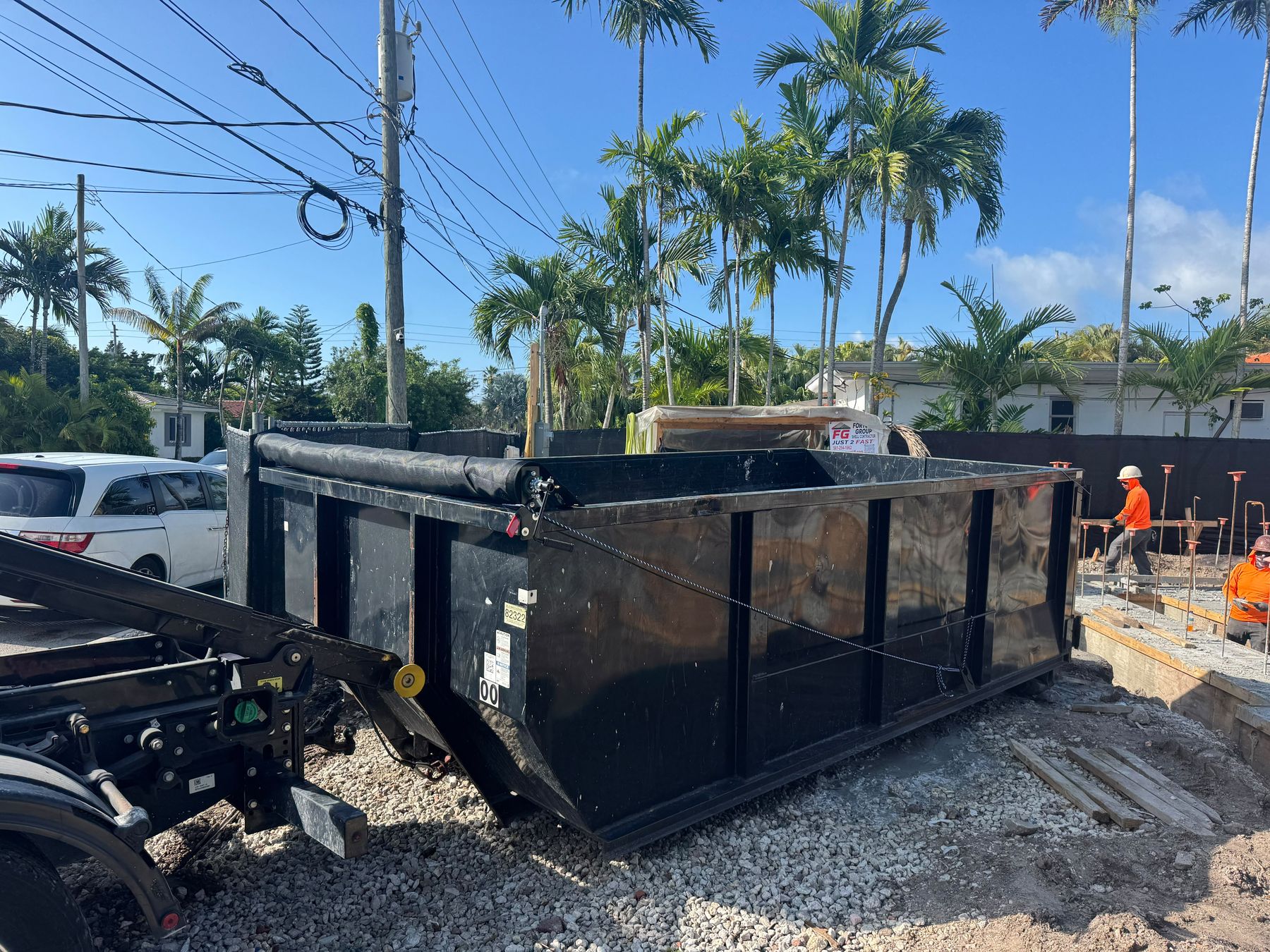 Roll-off dumpster delivery on a residential construction site