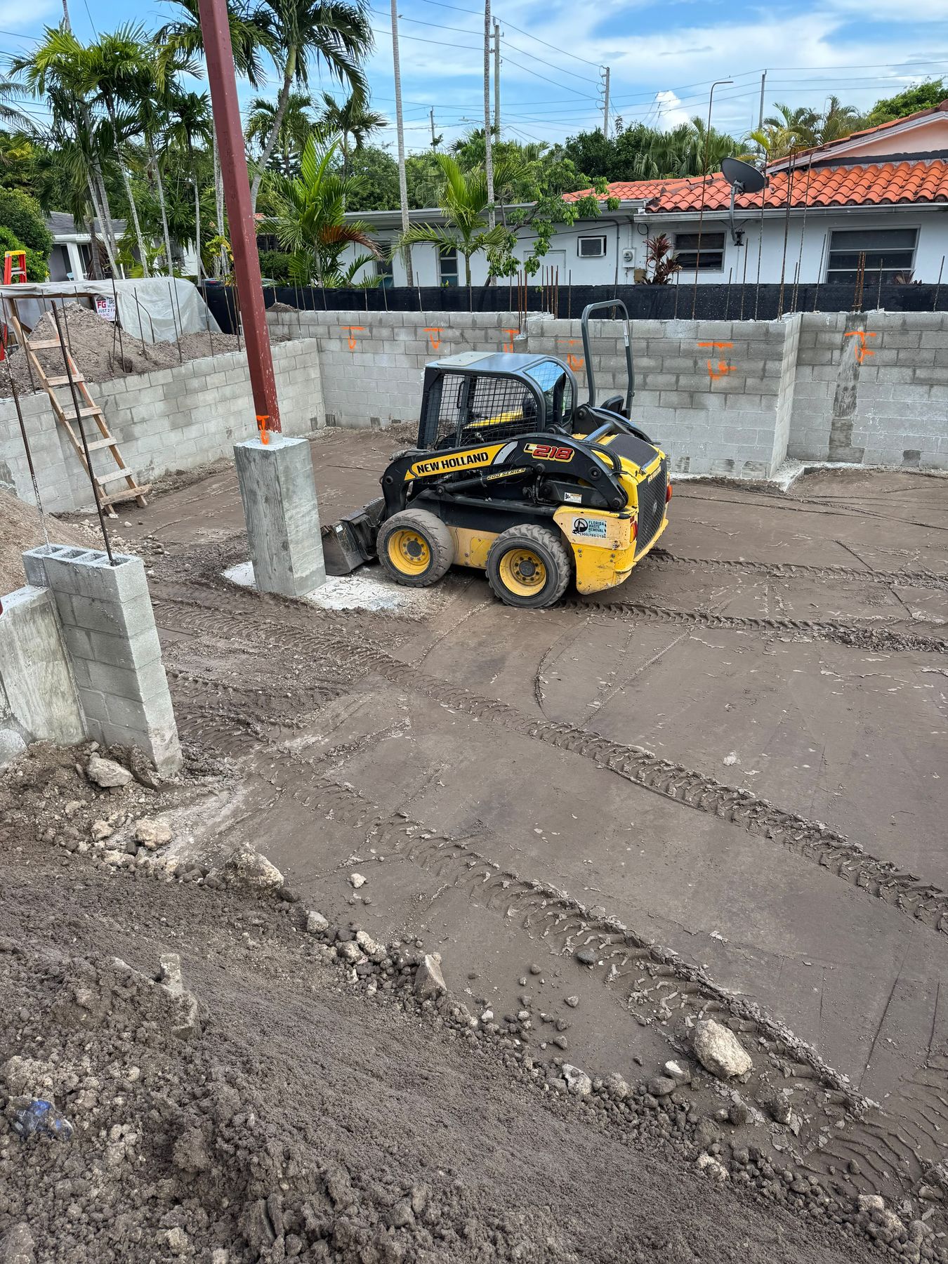 Skid steer grading inside a residential foundation