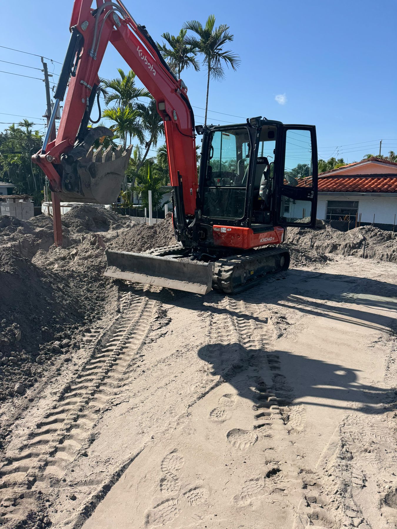 Red Kubota mini excavator for residential excavation